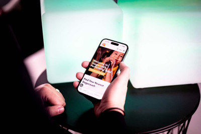 Hand holding iPhone showing Stagecoach Performing Arts mobile website