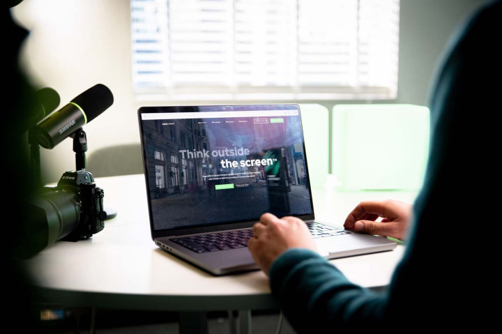 MWB website with Think outside the screen tagline on MacBook
