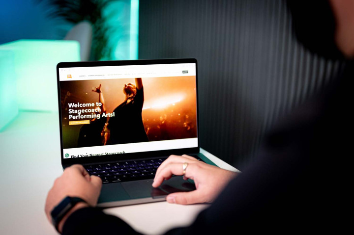 Stagecoach Performing Arts website homepage shown on a laptop