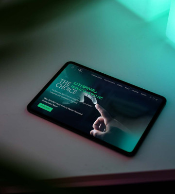Options Group website displayed on tablet lying flat on studio desk